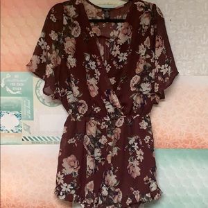 Maroon floral romper With a deep V-neck worn 1x